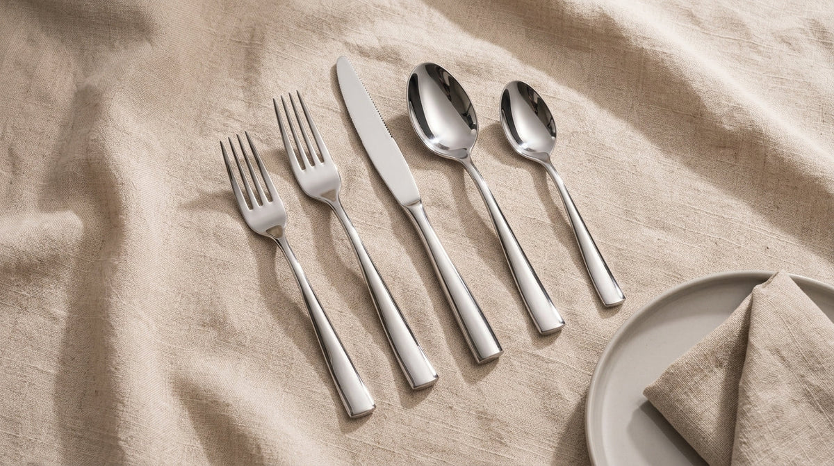 Barenthal stainless steel fork, spoon, and knife arranged on a neutral linen background