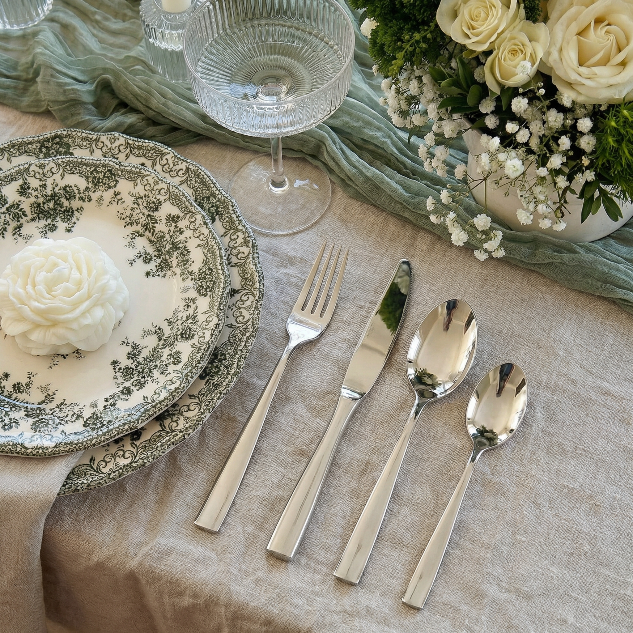 Barenthal Coutour flatware set styled in a rustic elegant dining scene, featuring dinner fork, knife, soup spoon, and teaspoon with vintage-inspired plates and linen tablecloth